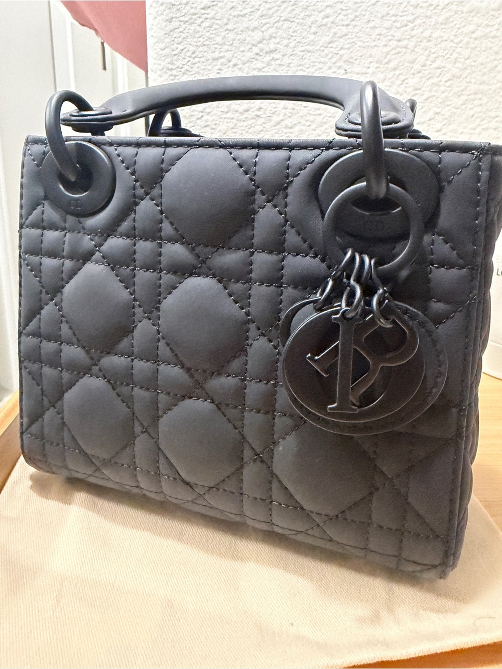 Matte Black Quilted Top-Handle Bag with Charm Accents